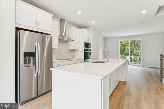 a kitchen with stainless steel appliances a refrigerator and a stove