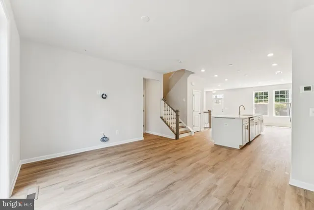 an entryway and hall with wooden floor