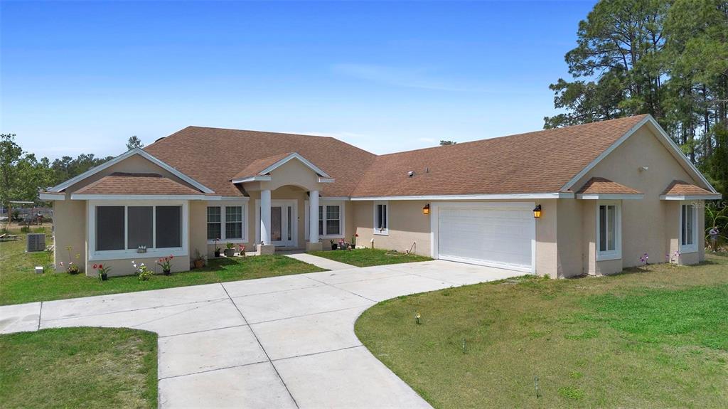 2048 Laredo Drive Deltona, FL 32738 - Photo 1 of 45 a view of house with a garden