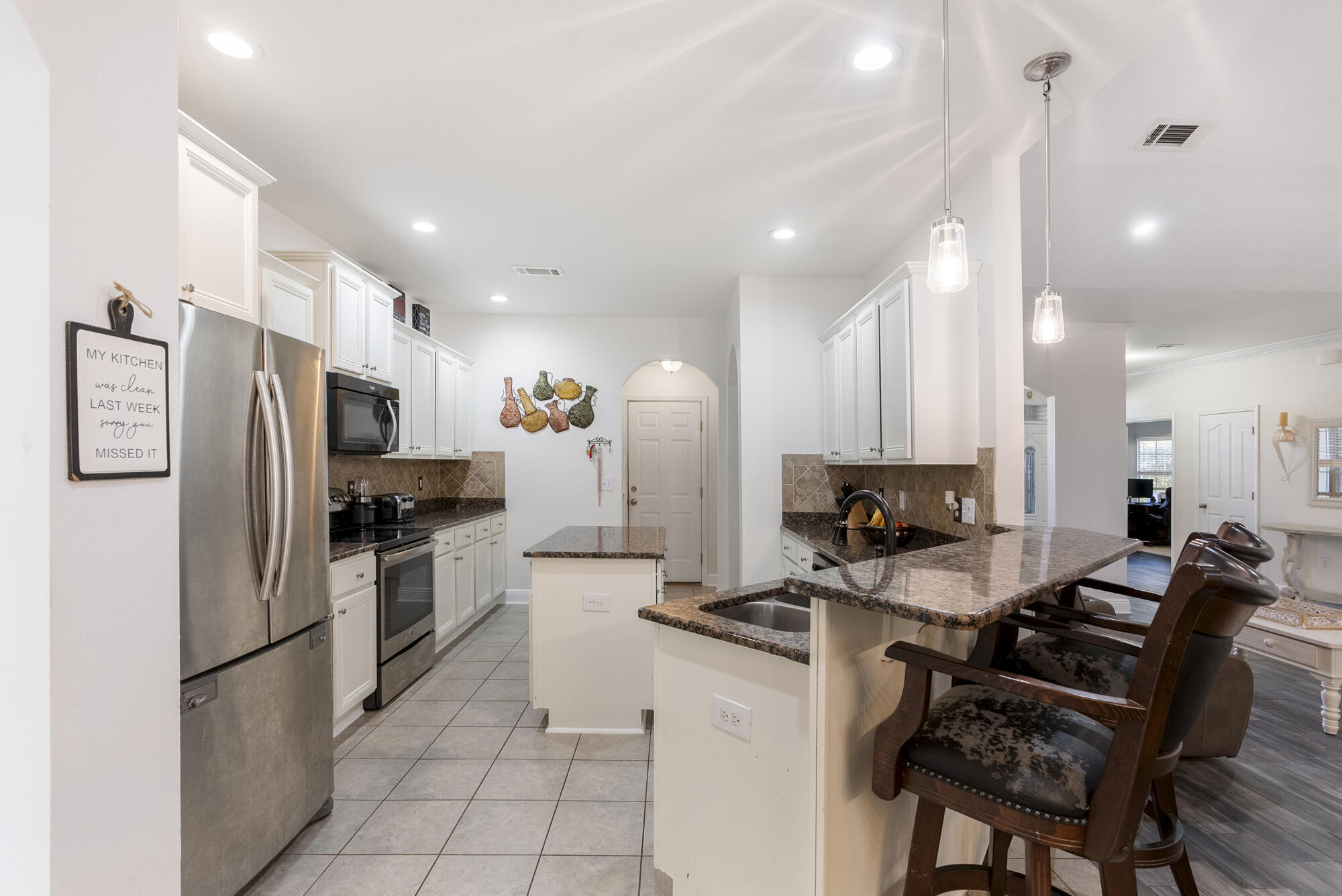 517 Pheasant Trail Crestview, FL 32536 - Photo 14 of 64 a kitchen with a refrigerator and a stove top oven