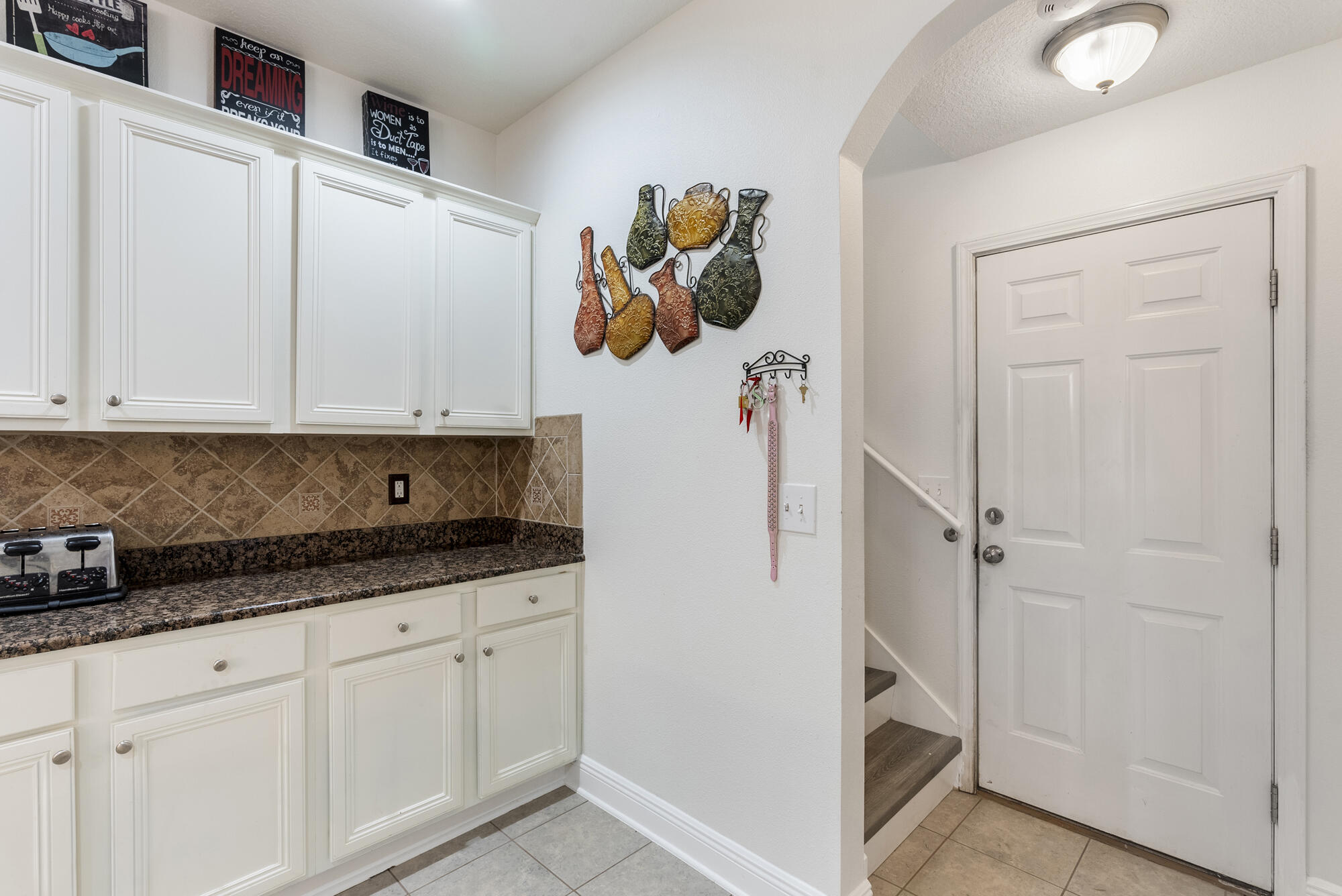 517 Pheasant Trail Crestview, FL 32536 - Photo 16 of 64 a kitchen with white cabinets and window
