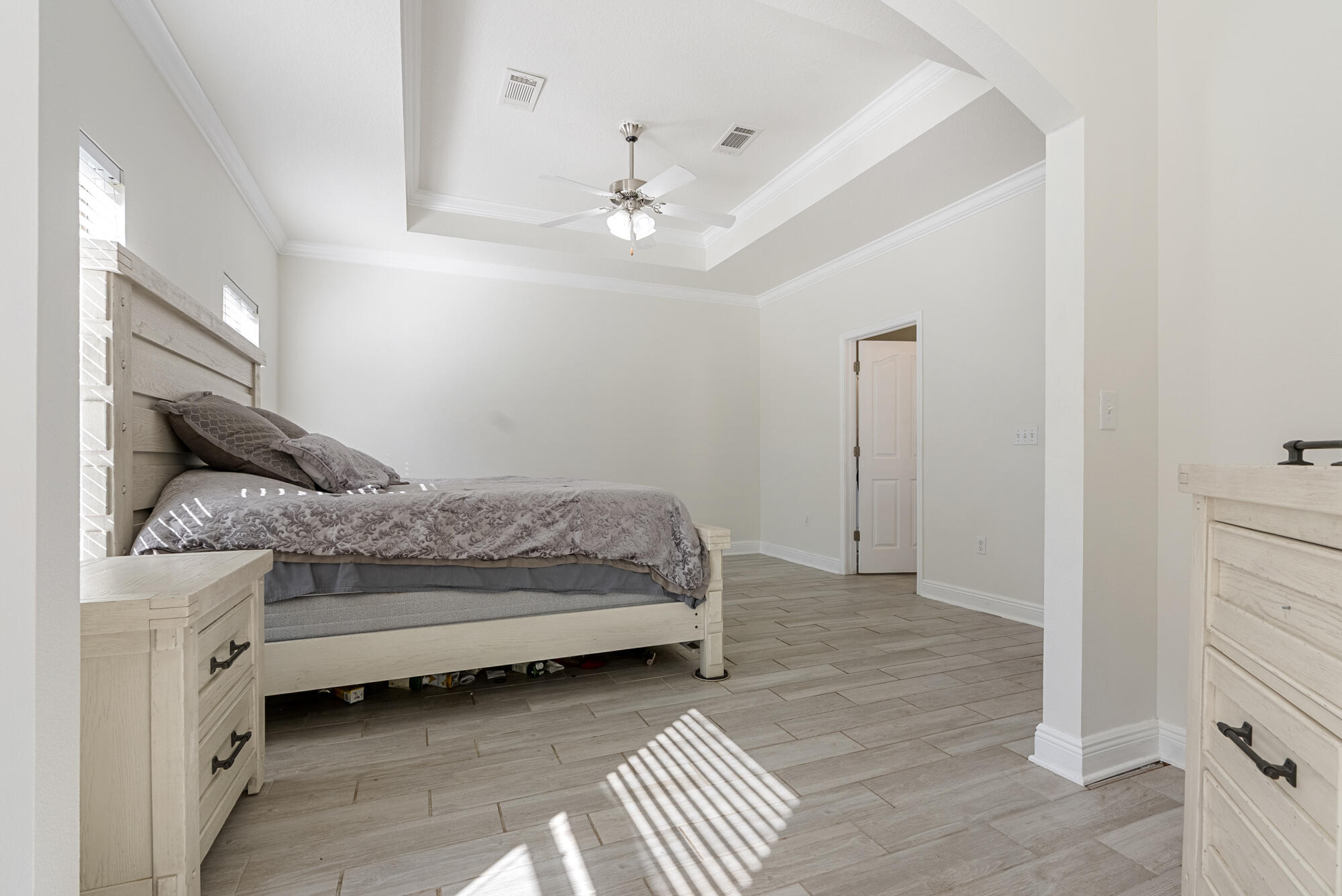 517 Pheasant Trail Crestview, FL 32536 - Photo 21 of 64 a bedroom with a bed and a chandelier