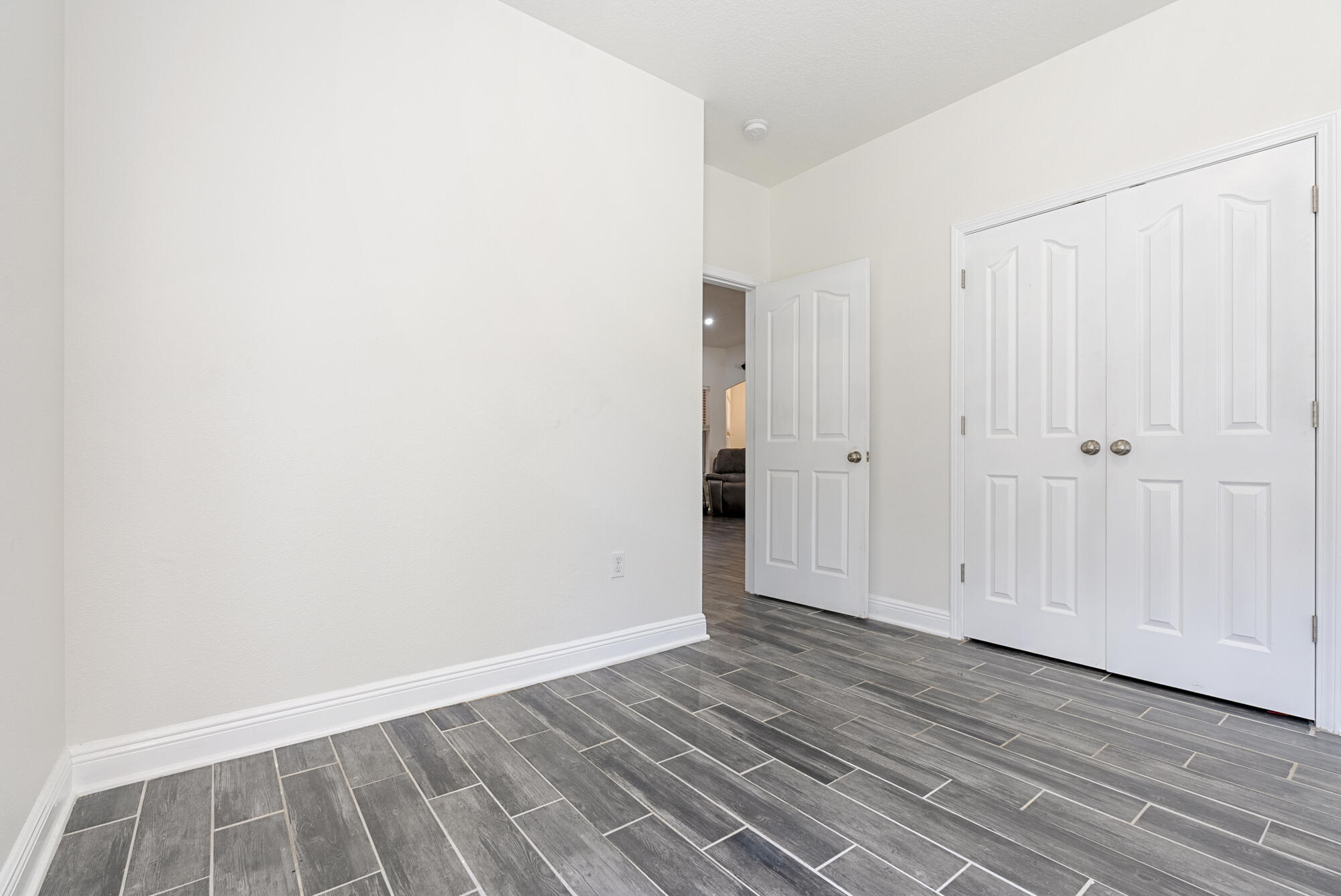 517 Pheasant Trail Crestview, FL 32536 - Photo 26 of 64 a view of an empty room with wooden floor