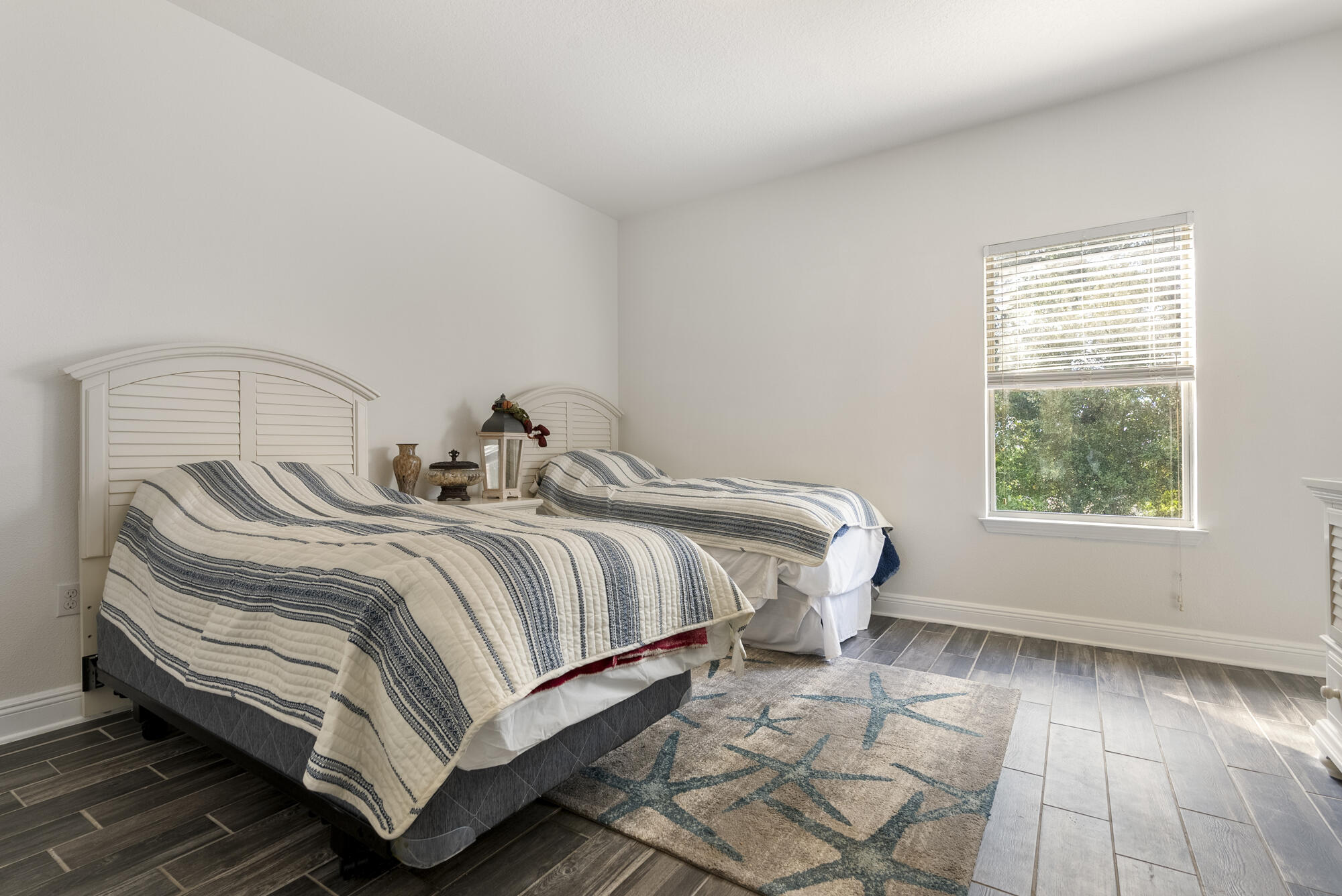 517 Pheasant Trail Crestview, FL 32536 - Photo 28 of 64 a bedroom with a bed and wooden floor