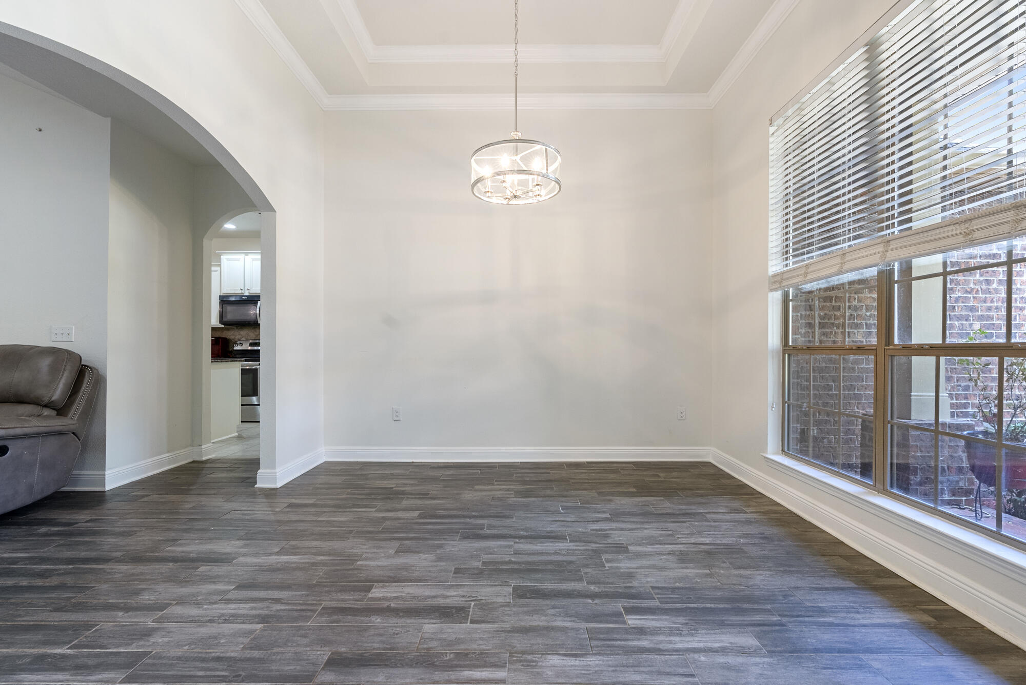 517 Pheasant Trail Crestview, FL 32536 - Photo 4 of 64 a view of an empty room with wooden floor and a window