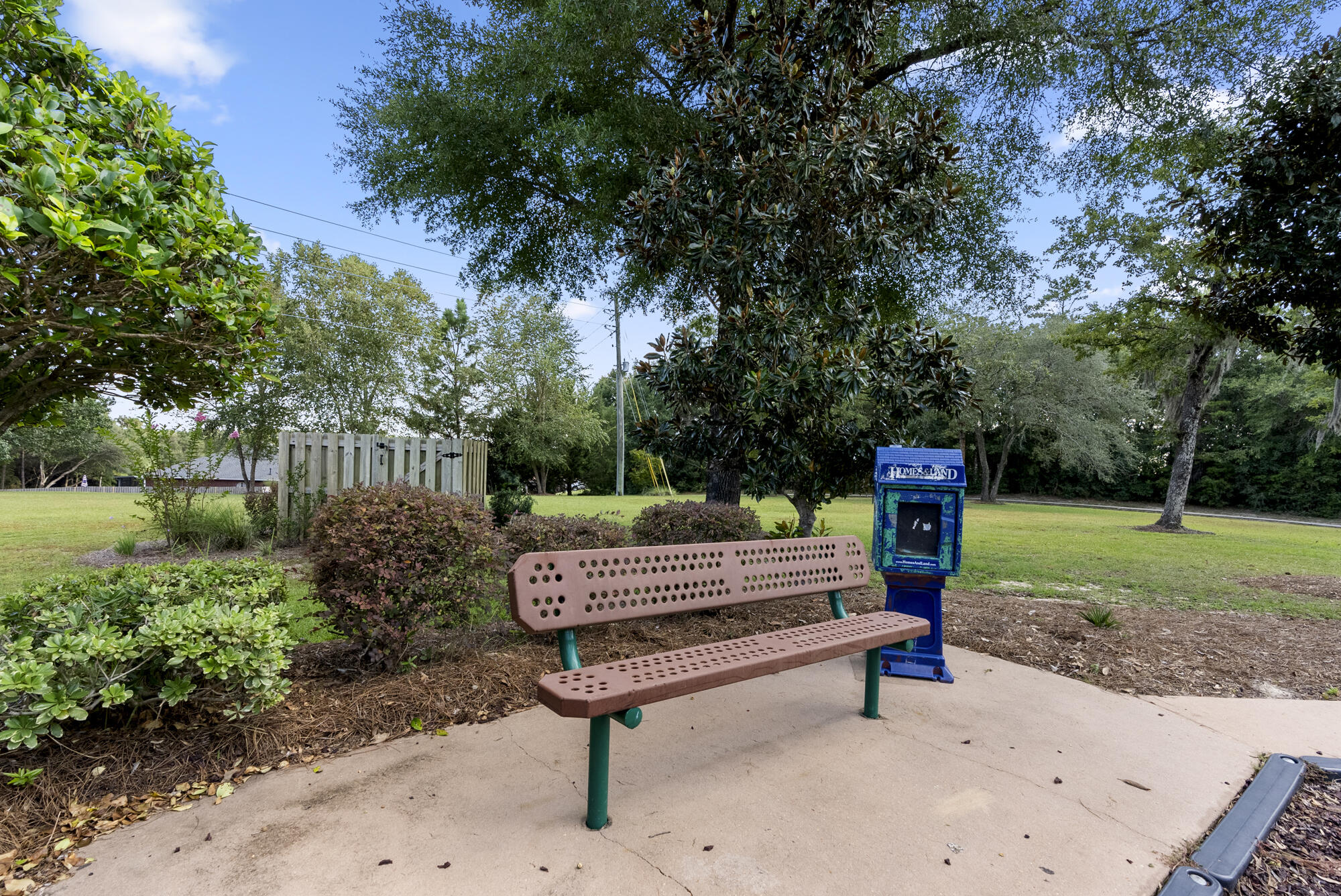 517 Pheasant Trail Crestview, FL 32536 - Photo 50 of 64 a view of a bench in the garden near a lake