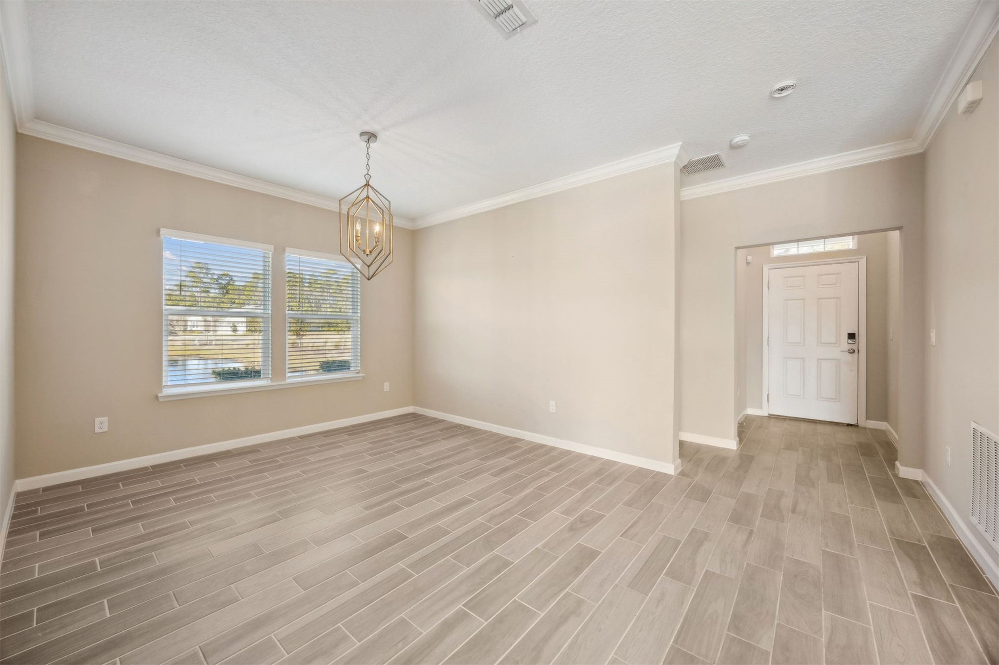 85237 Fall River Parkway Fernandina Beach, FL 32034 - Photo 13 of 88 a view of an empty room with wooden floor and a window