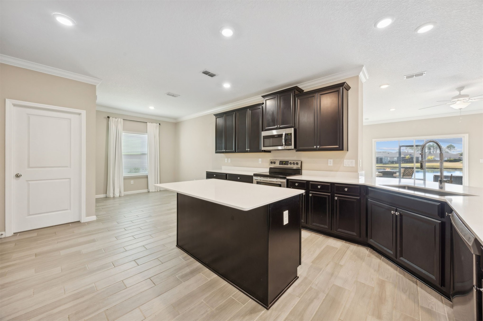 85237 Fall River Parkway Fernandina Beach, FL 32034 - Photo 16 of 88 a kitchen with stainless steel appliances granite countertop a stove top oven and sink