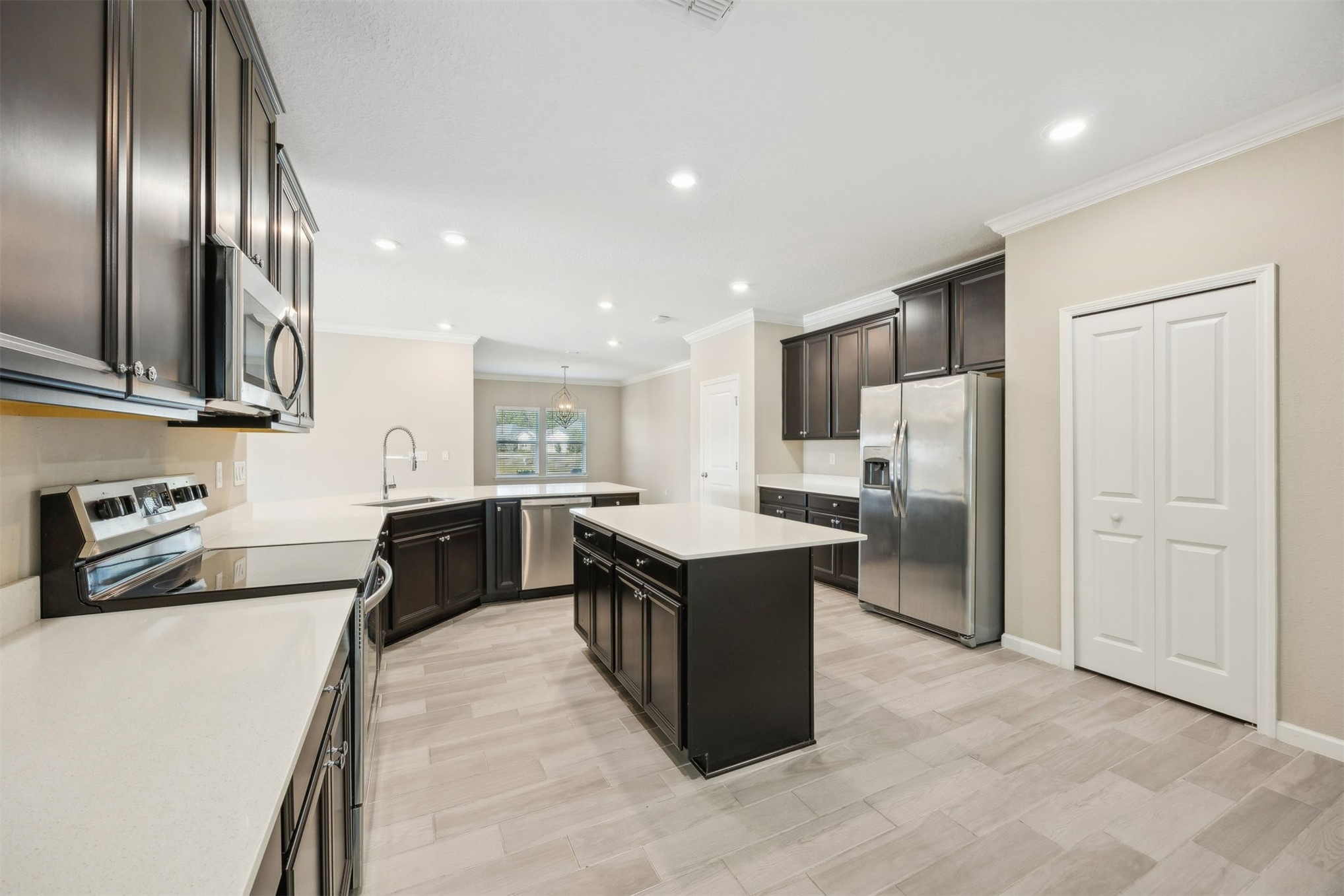 85237 Fall River Parkway Fernandina Beach, FL 32034 - Photo 18 of 88 a kitchen with stainless steel appliances granite countertop a refrigerator a sink dishwasher a stove and a refrigerator with wooden floor