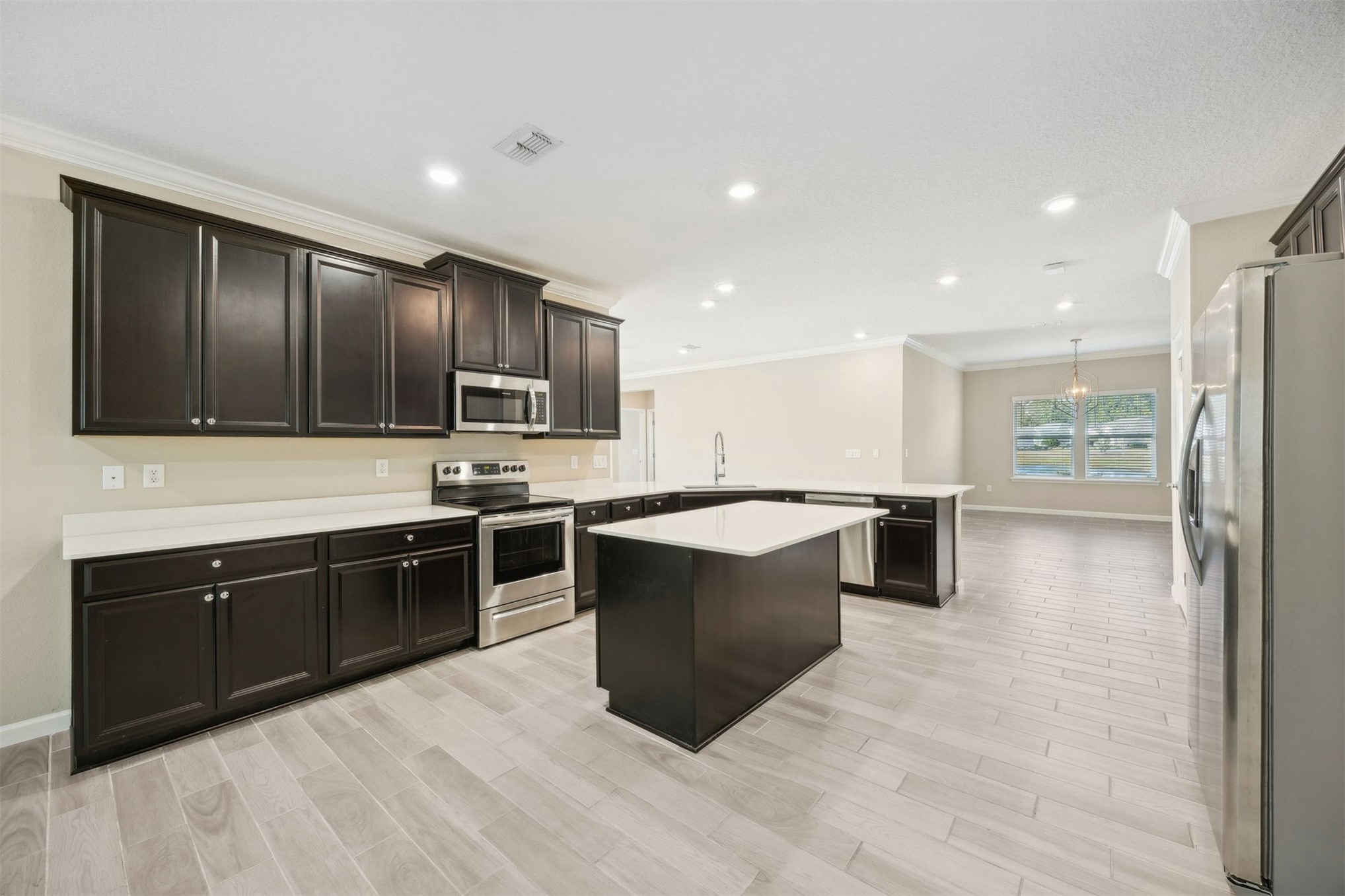 85237 Fall River Parkway Fernandina Beach, FL 32034 - Photo 19 of 88 a large kitchen with stainless steel appliances kitchen island granite countertop a large counter top and oven
