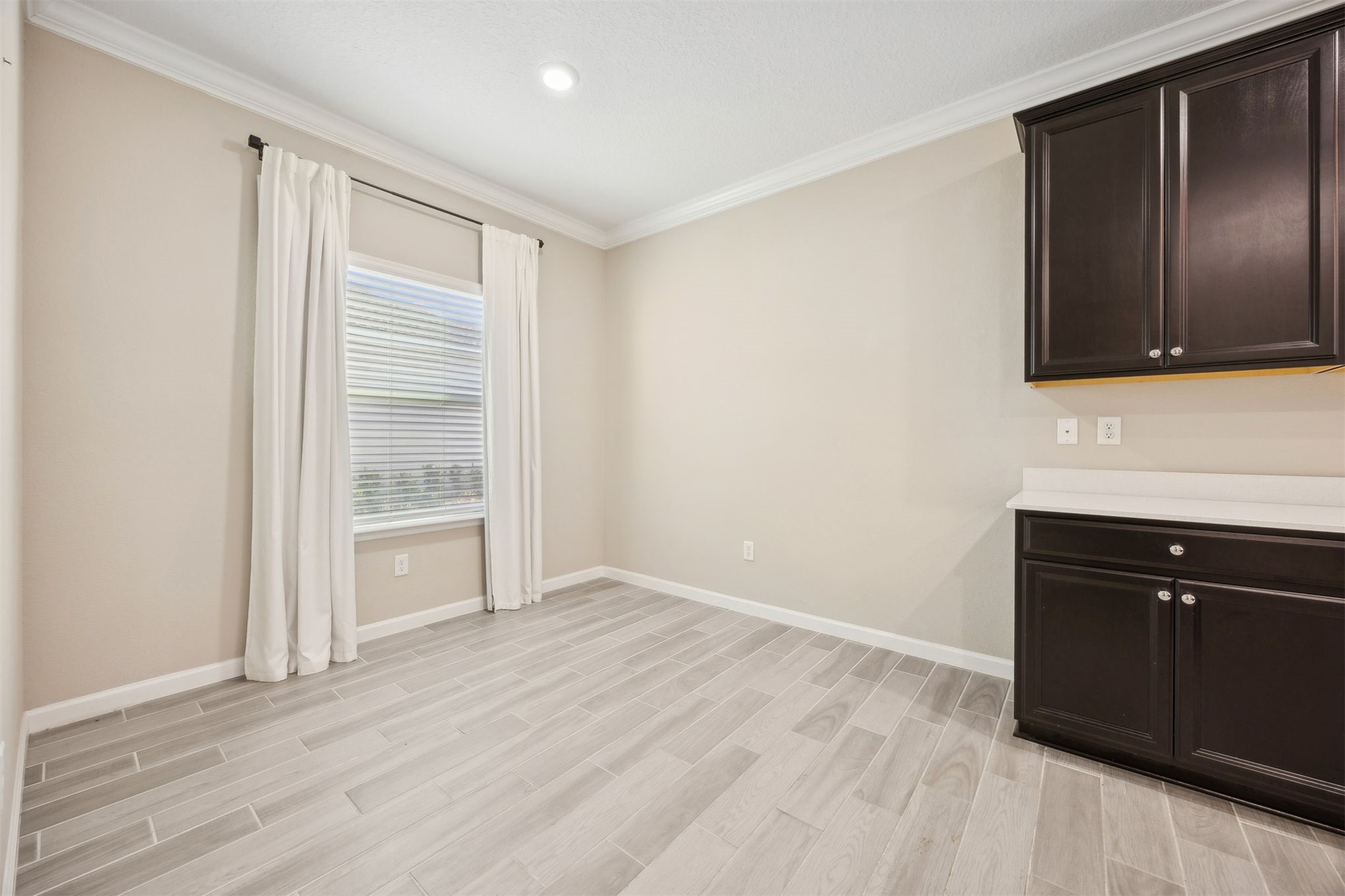 85237 Fall River Parkway Fernandina Beach, FL 32034 - Photo 20 of 88 a view of an empty room with wooden floor and cabinets