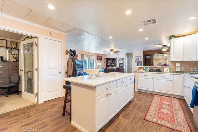 a large white kitchen with a stove and a refrigerator