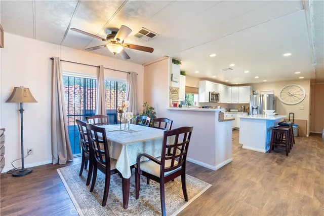 a living room with lots of furniture and kitchen view