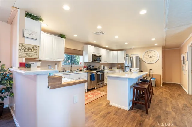 a kitchen with a sink cabinets and wooden floor