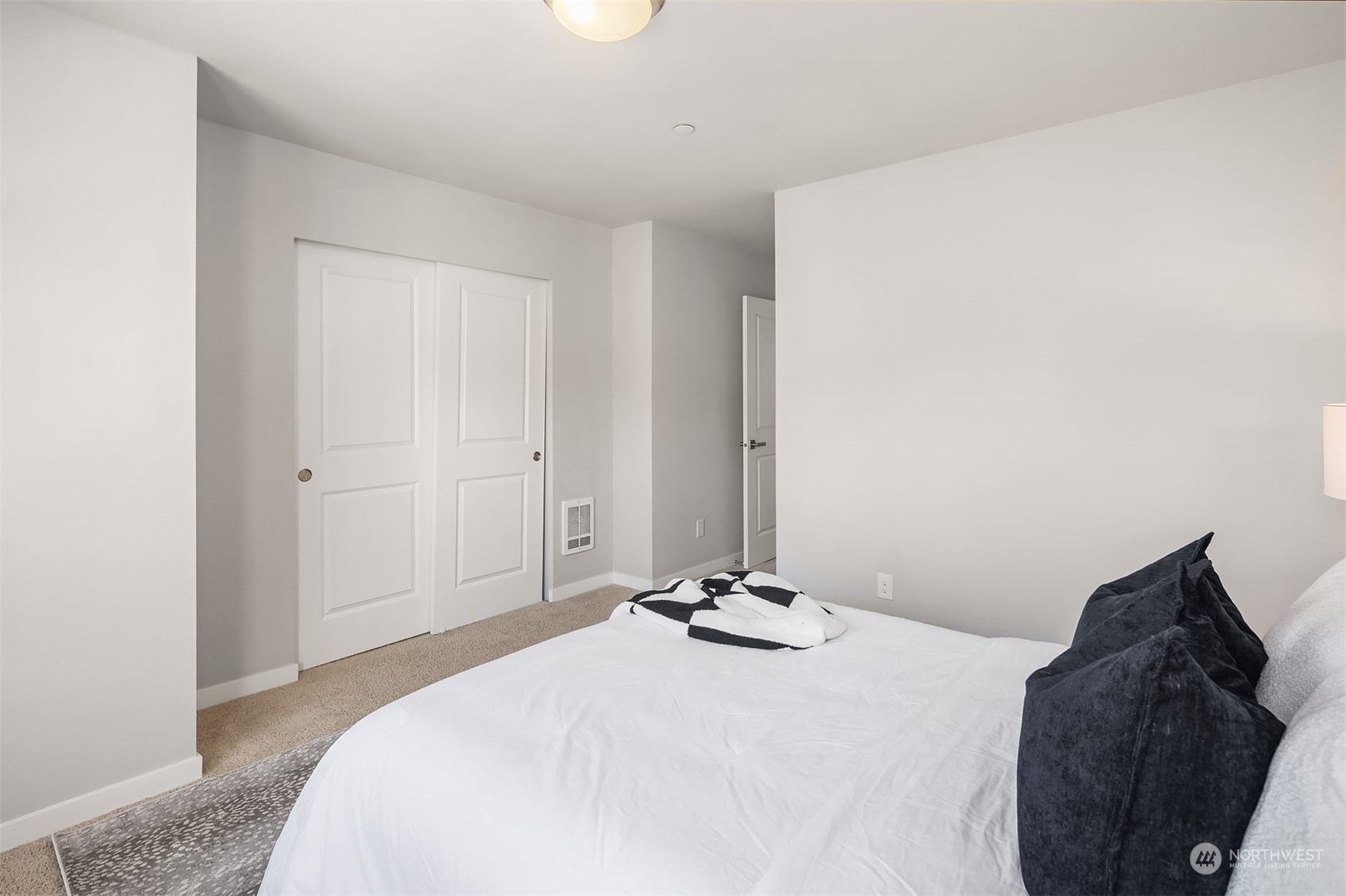 15720 Meadow Road, Unit C2 Lynnwood, WA 98087 - Photo 19 of 23 a bedroom with a bed and a mirror