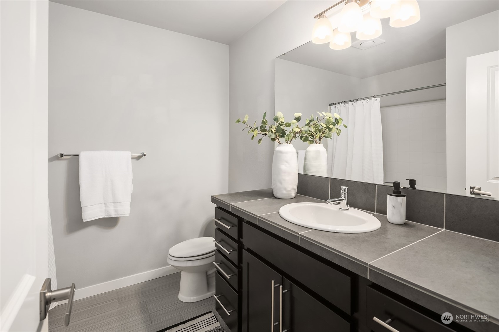 15720 Meadow Road, Unit C2 Lynnwood, WA 98087 - Photo 20 of 23 a bathroom with a granite countertop sink a toilet and a mirror