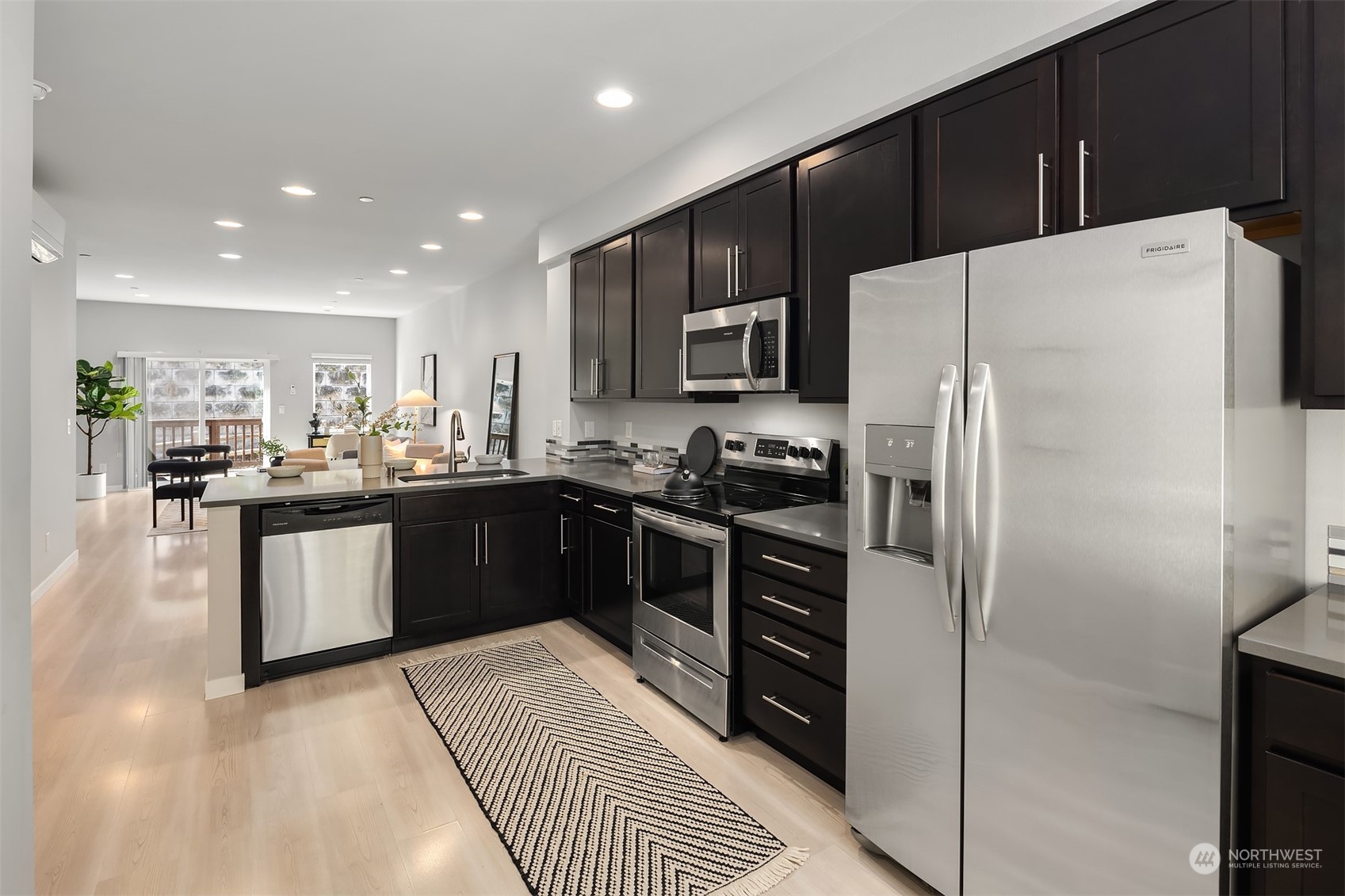 15720 Meadow Road, Unit C2 Lynnwood, WA 98087 - Photo 10 of 23 a kitchen with stainless steel appliances a refrigerator stove microwave and cabinets