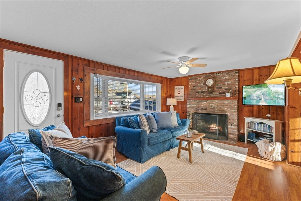 2 Uncle Edwards Road Mashpee, MA 02649 - Photo 12 of 42 a living room with furniture a fireplace and a large window