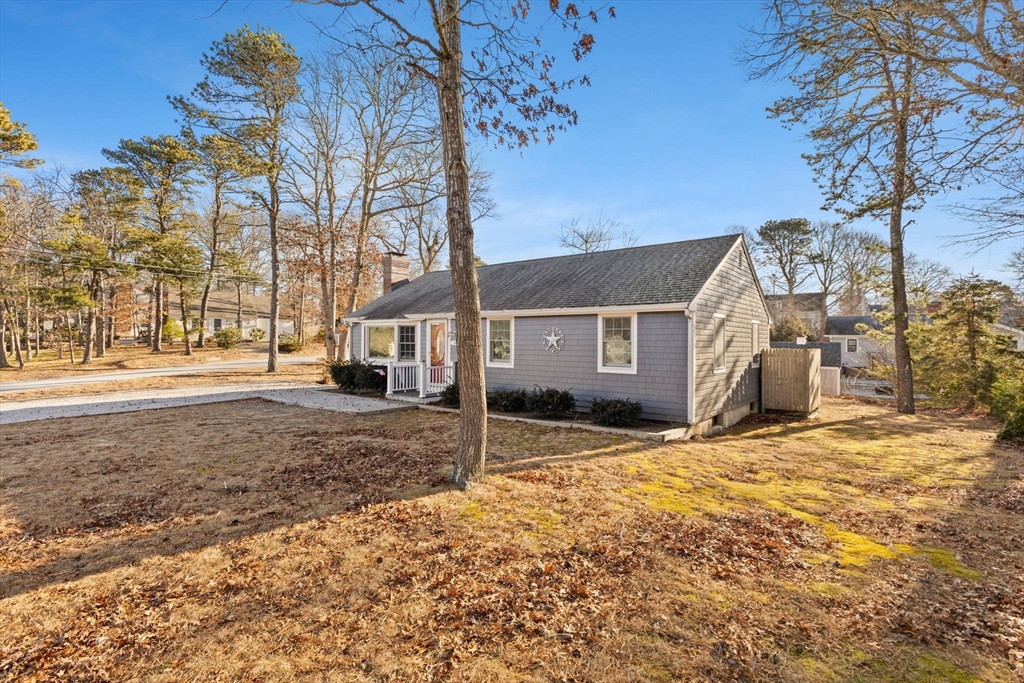 2 Uncle Edwards Road Mashpee, MA 02649 - Photo 2 of 42 a view of a house with a yard covered in snow