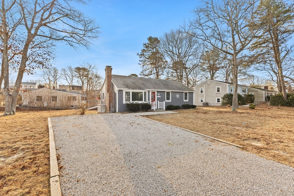 2 Uncle Edwards Road Mashpee, MA 02649 - Photo 3 of 42 a front view of a building with large trees