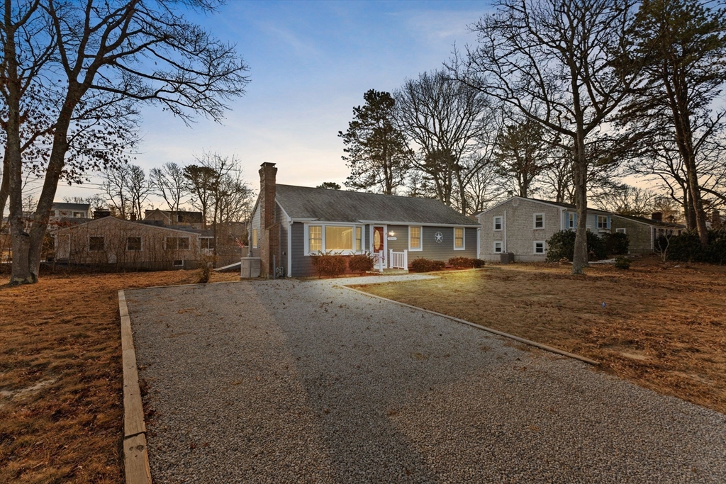 2 Uncle Edwards Road Mashpee, MA 02649 - Photo 39 of 42 a front view of a house with a yard