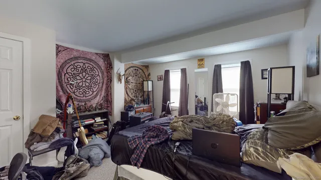 a bed room with furniture and gym equipment