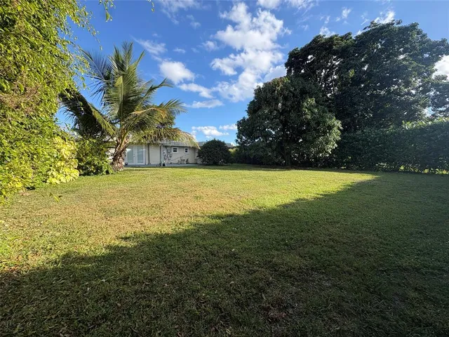 a view of yard with swimming pool and outdoor seating
