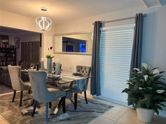 a view of a dining room with furniture and flower pot