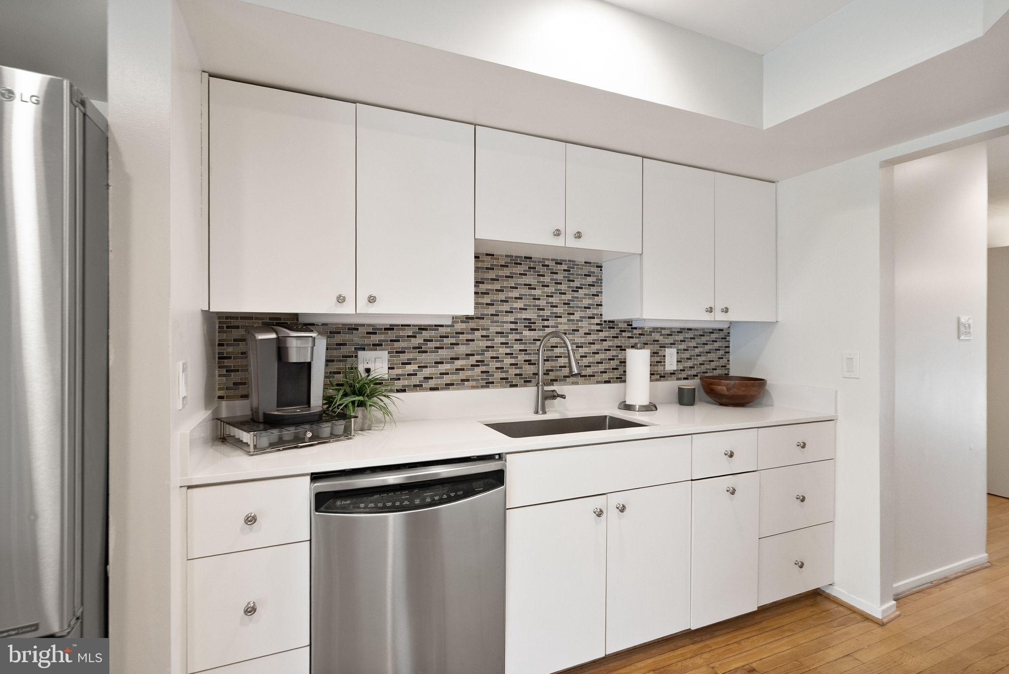 2013 Turtle Pond Drive Reston, VA 20191 - Photo 16 of 62 a kitchen with white cabinets white stainless steel appliances and sink