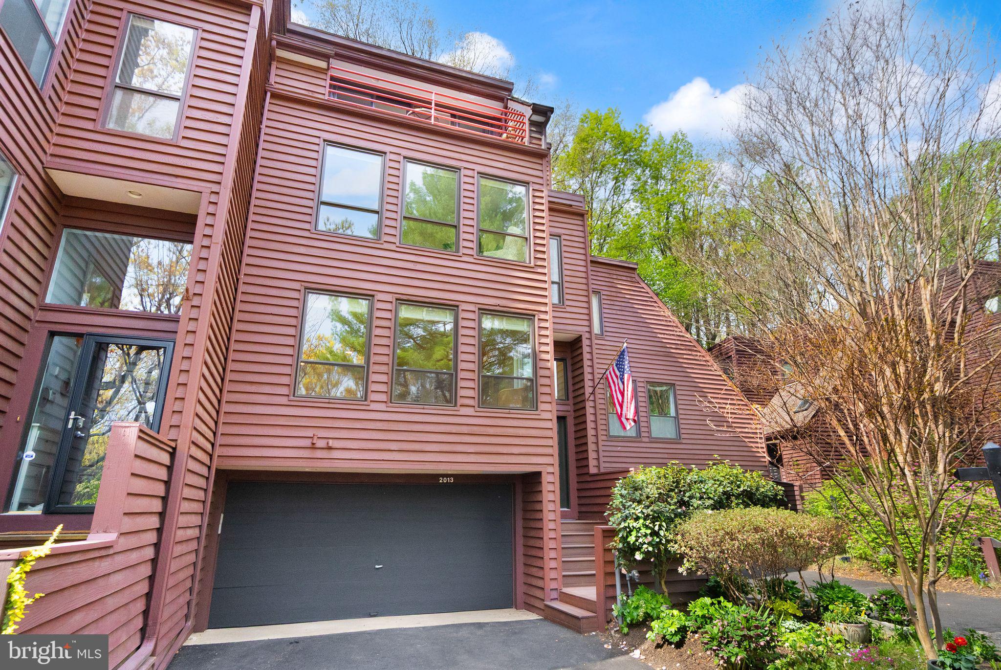 2013 Turtle Pond Drive Reston, VA 20191 - Photo 2 of 62 a front view of a house with a yard and garage