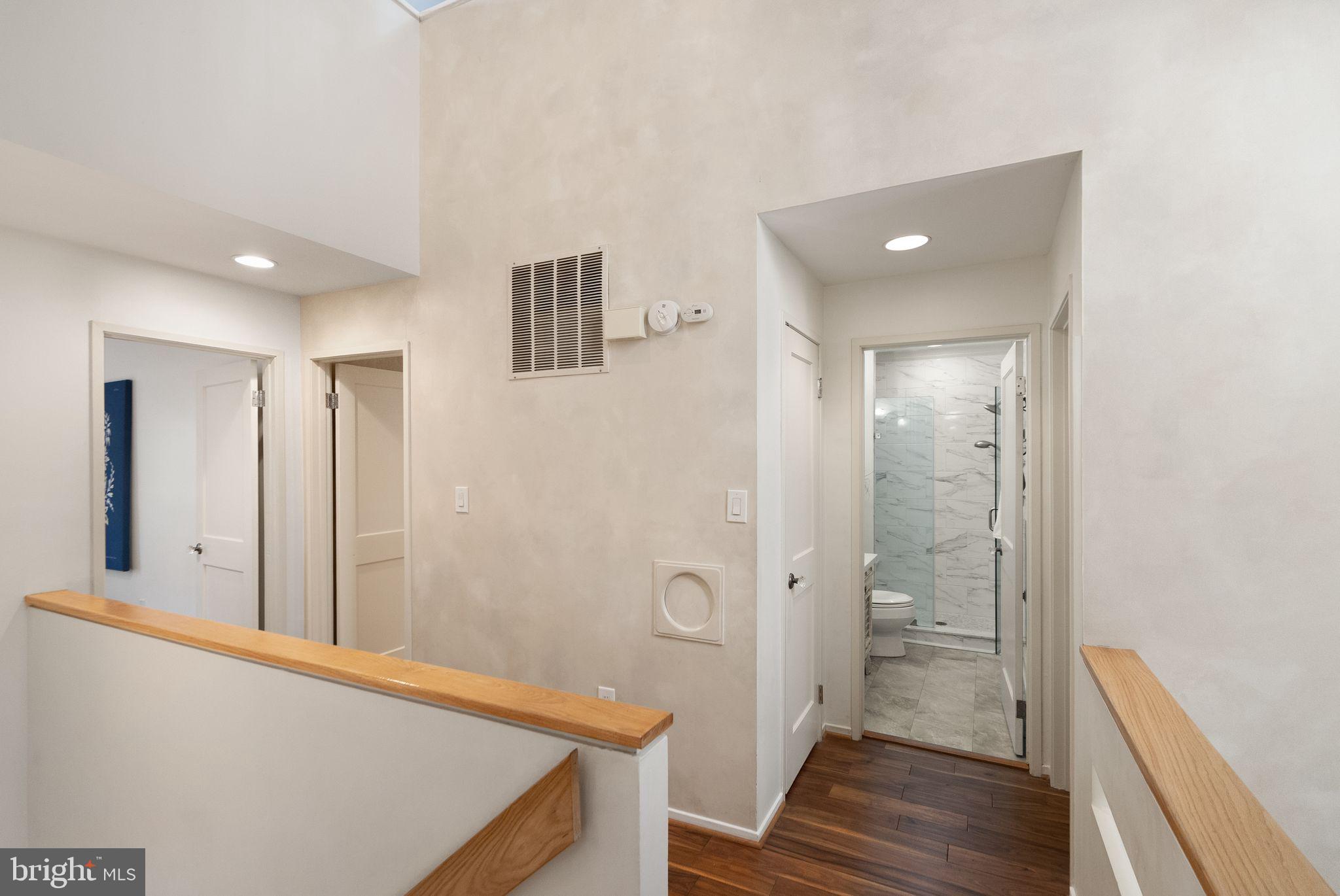 2013 Turtle Pond Drive Reston, VA 20191 - Photo 21 of 62 a view of a hallway with wooden floor and a bathroom
