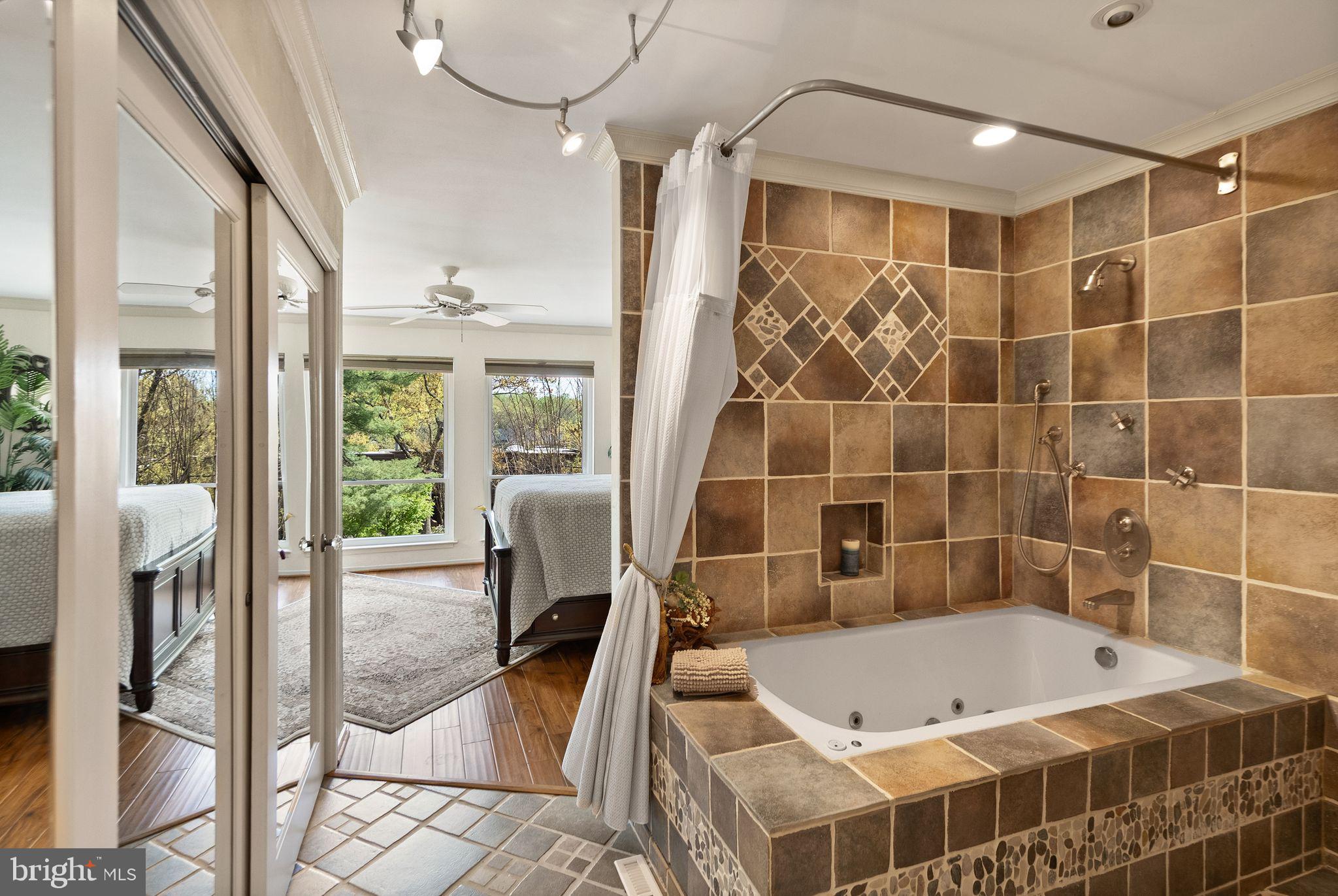 2013 Turtle Pond Drive Reston, VA 20191 - Photo 28 of 62 a bathroom with a tub and a shower