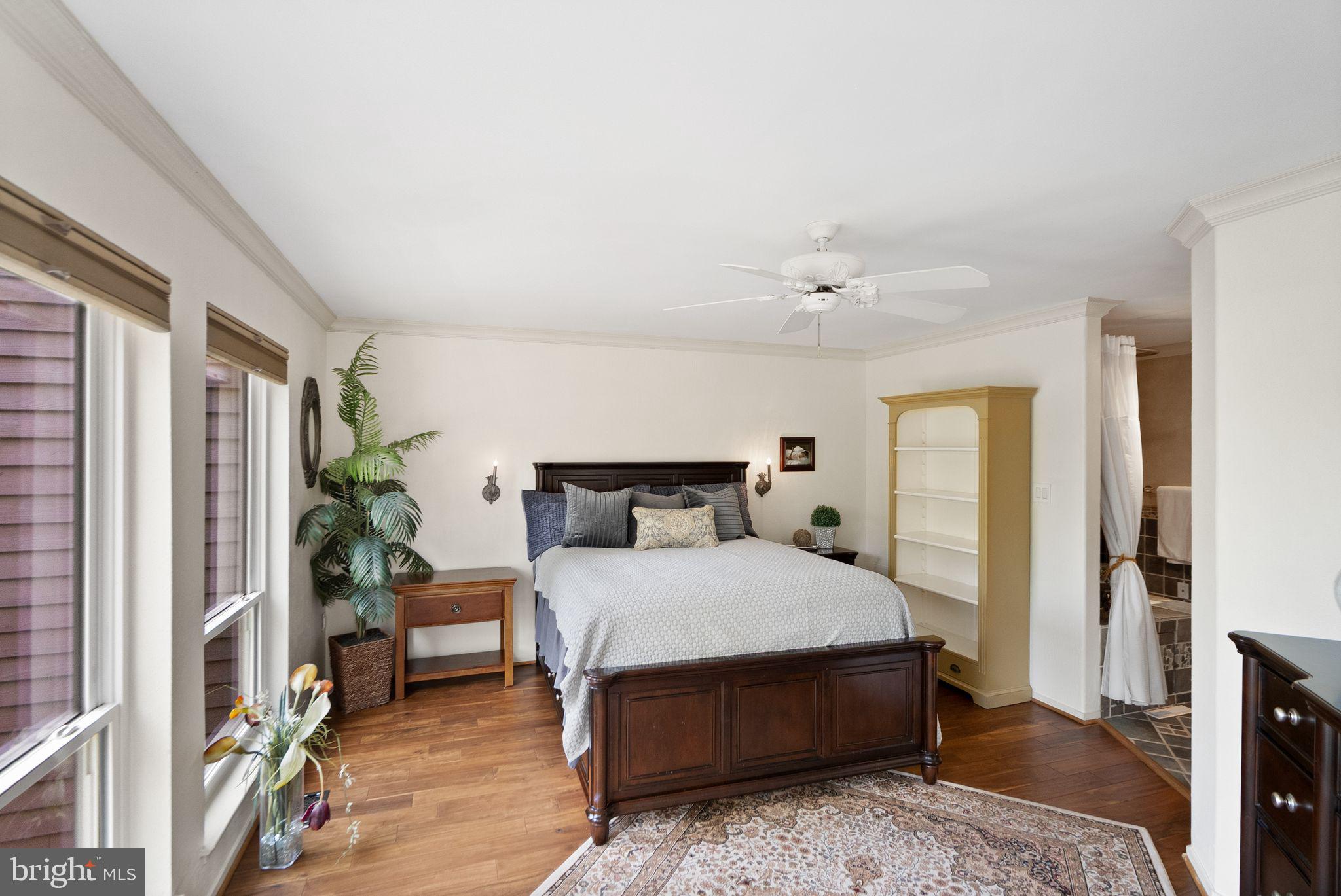 2013 Turtle Pond Drive Reston, VA 20191 - Photo 31 of 62 a bedroom with a bed lamp and a potted plant