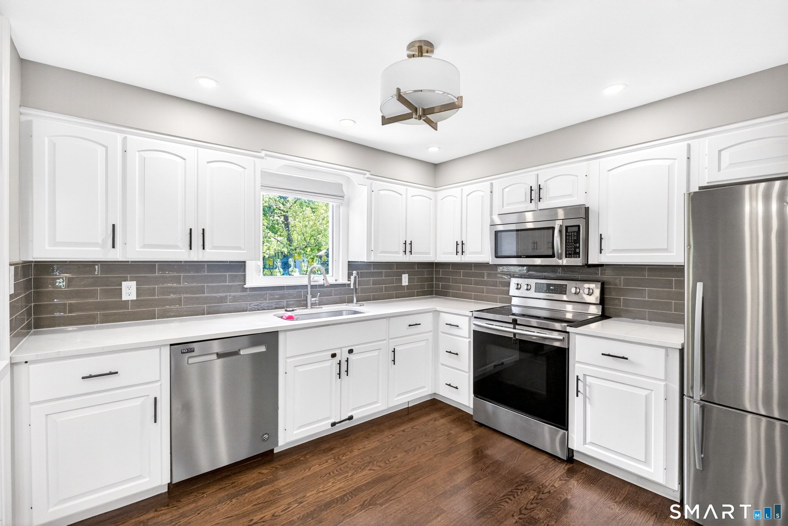 568 Wiese Road Cheshire, CT 06410 - Photo 12 of 40 a kitchen with white cabinets and white appliances