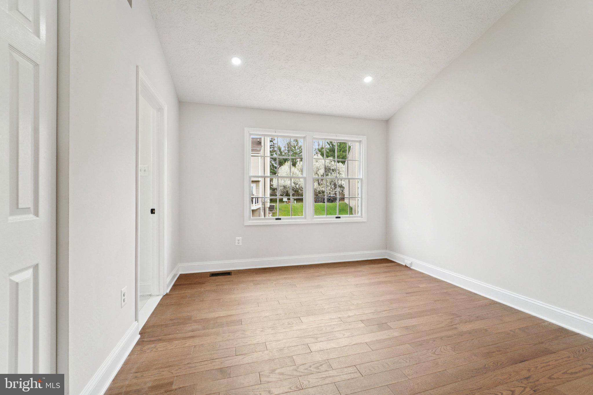 8727 Silver Hall Road Perry Hall, MD 21128 - Photo 13 of 35 wooden floor in an empty room with a window