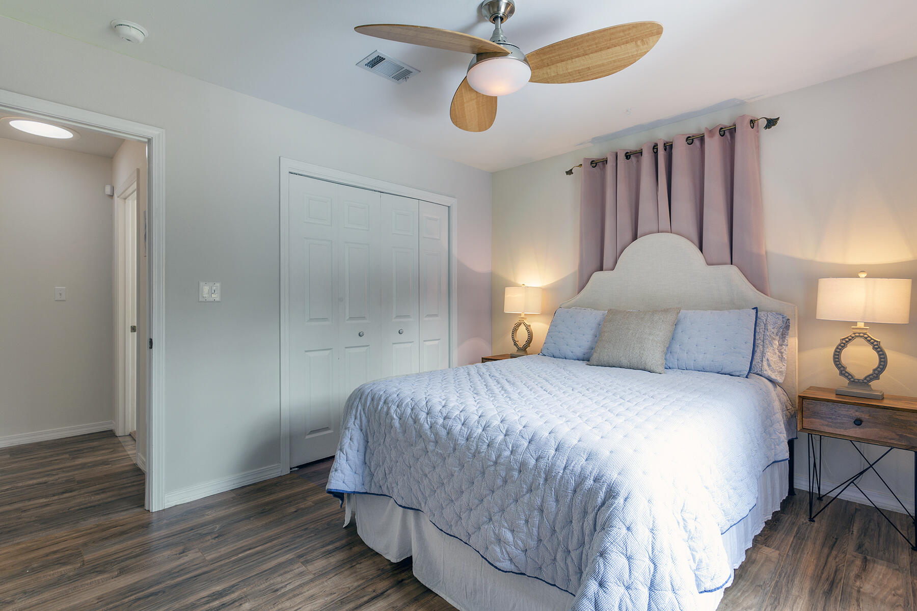 140 East Wild Blueberry Way Santa Rosa Beach, FL 32459 - Photo 34 of 48 a bedroom with a bed and wooden floor