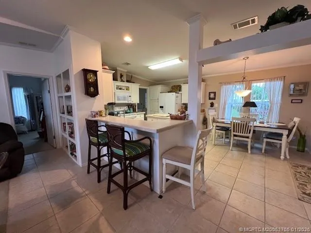 a view of a hallway with workspace and dining room view