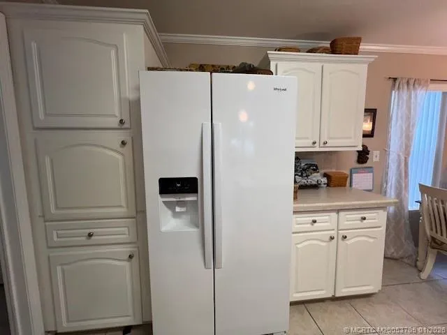 a white refrigerator freezer sitting in a kitchen