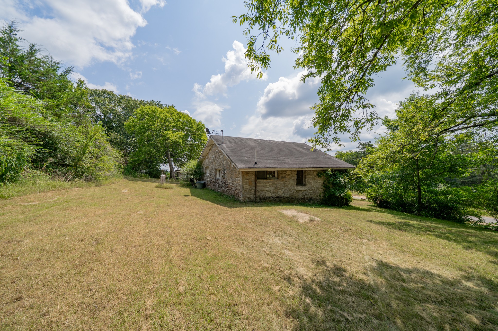 44 Cedar Circle Mulberry, TN 37359 - Photo 11 of 20 a backyard of a house with plants and large trees