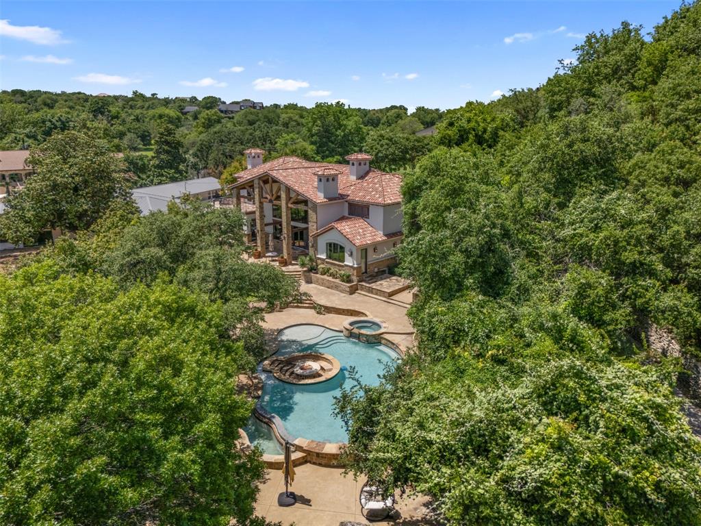 9930 Boat Club Road Fort Worth, TX 76179 - Photo 3 of 40 Perched in the hills and surrounded by lush greenery, Eagle Manor is a secluded paradise designed for relaxation and breathtaking views.