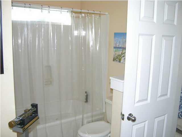 27 Hatchew Road Destin, FL 32550 - Photo 25 of 31 a bathroom with a shower curtain