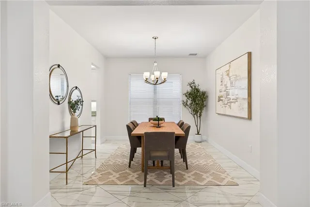 a dining room with a table chairs and a chandelier