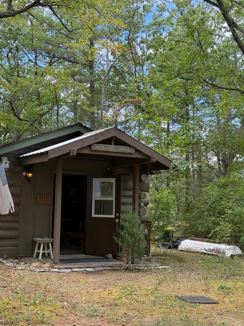 0 Rock Ledge Road West Milford, NJ 07480 - Photo 2 of 17 a backyard of a house with large trees and wooden fence