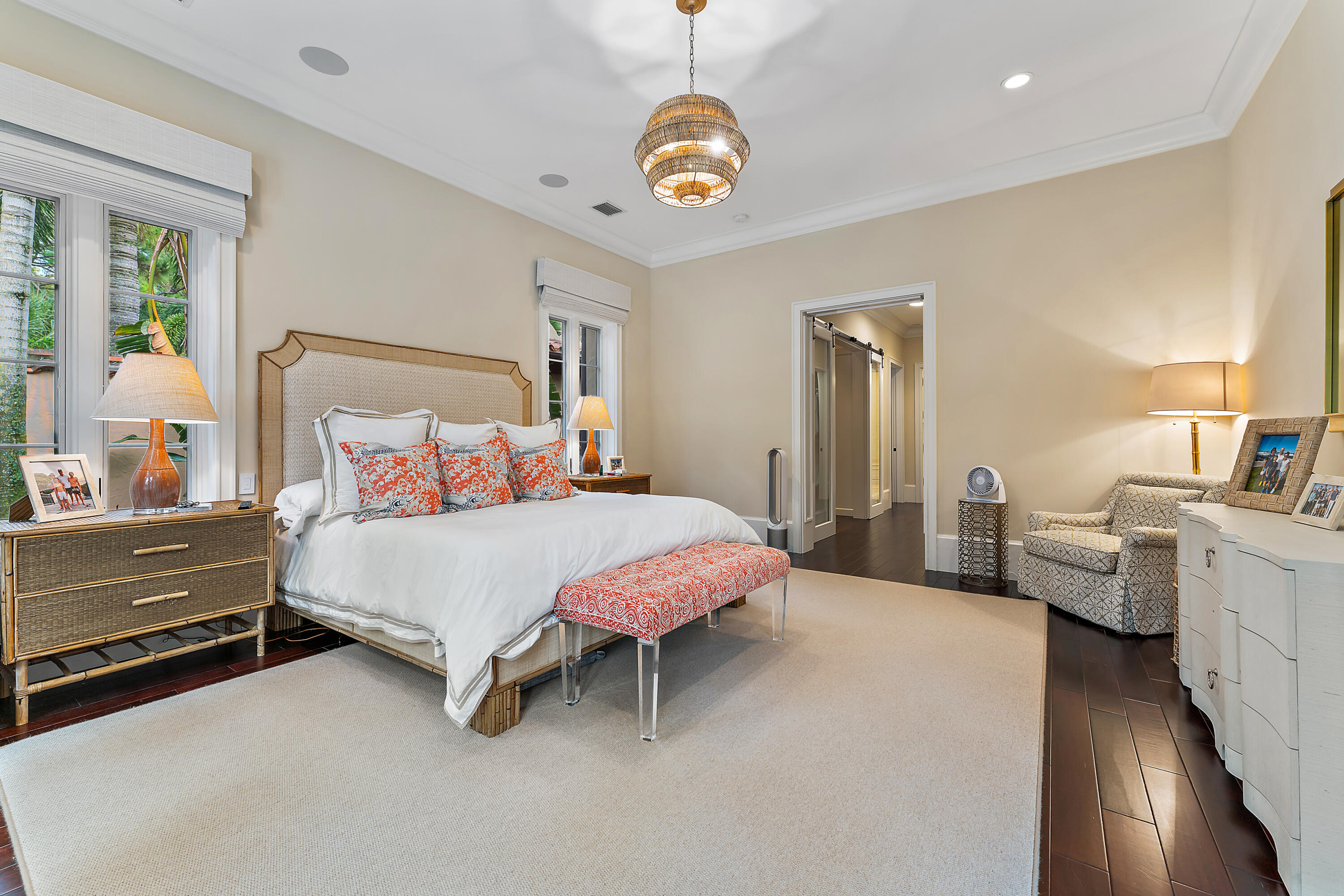 426 Via Del Orso Drive Jupiter, FL 33477 - Photo 29 of 54 a spacious bedroom with a bed and a chandelier