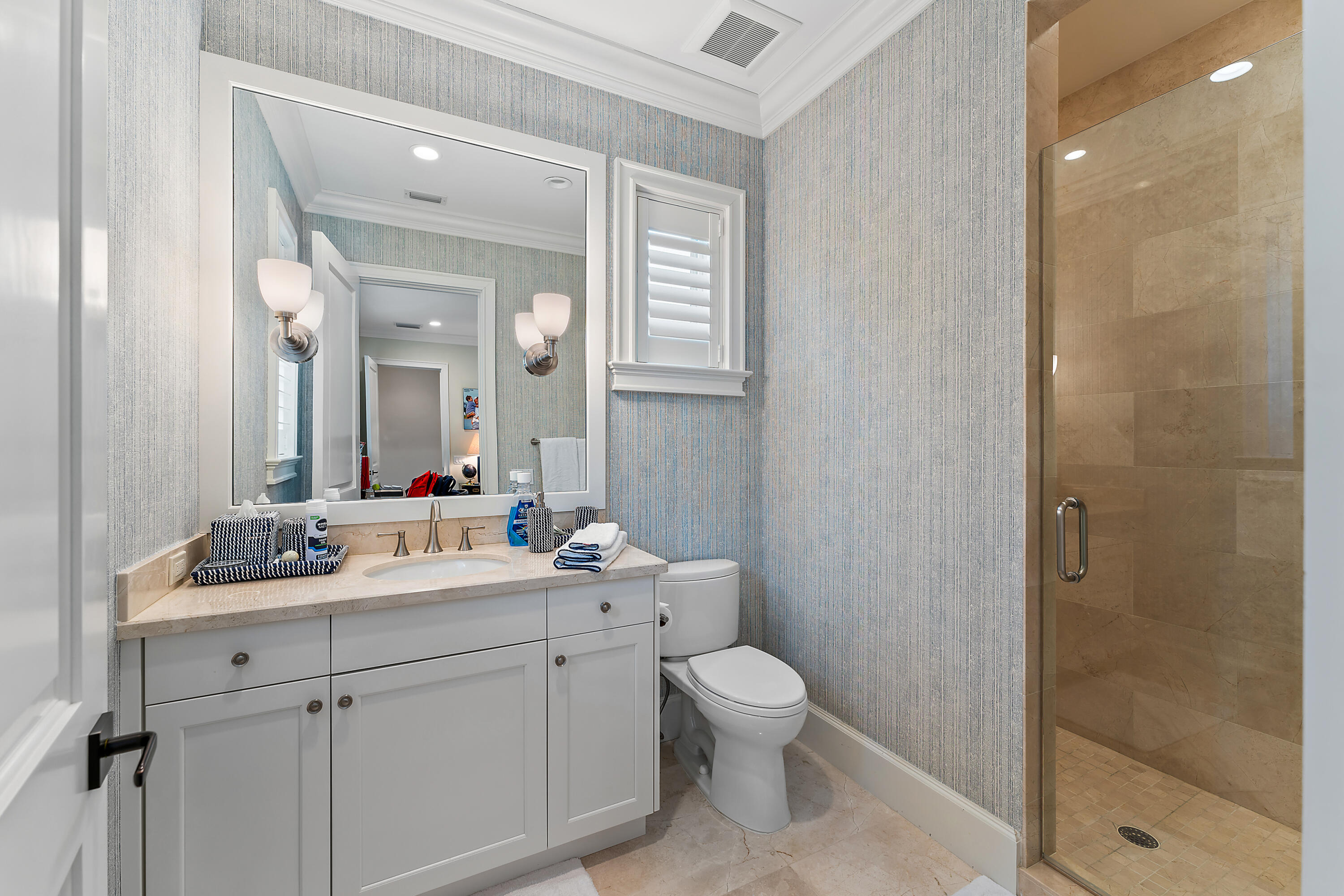 426 Via Del Orso Drive Jupiter, FL 33477 - Photo 41 of 54 a bathroom with a toilet a sink and mirror