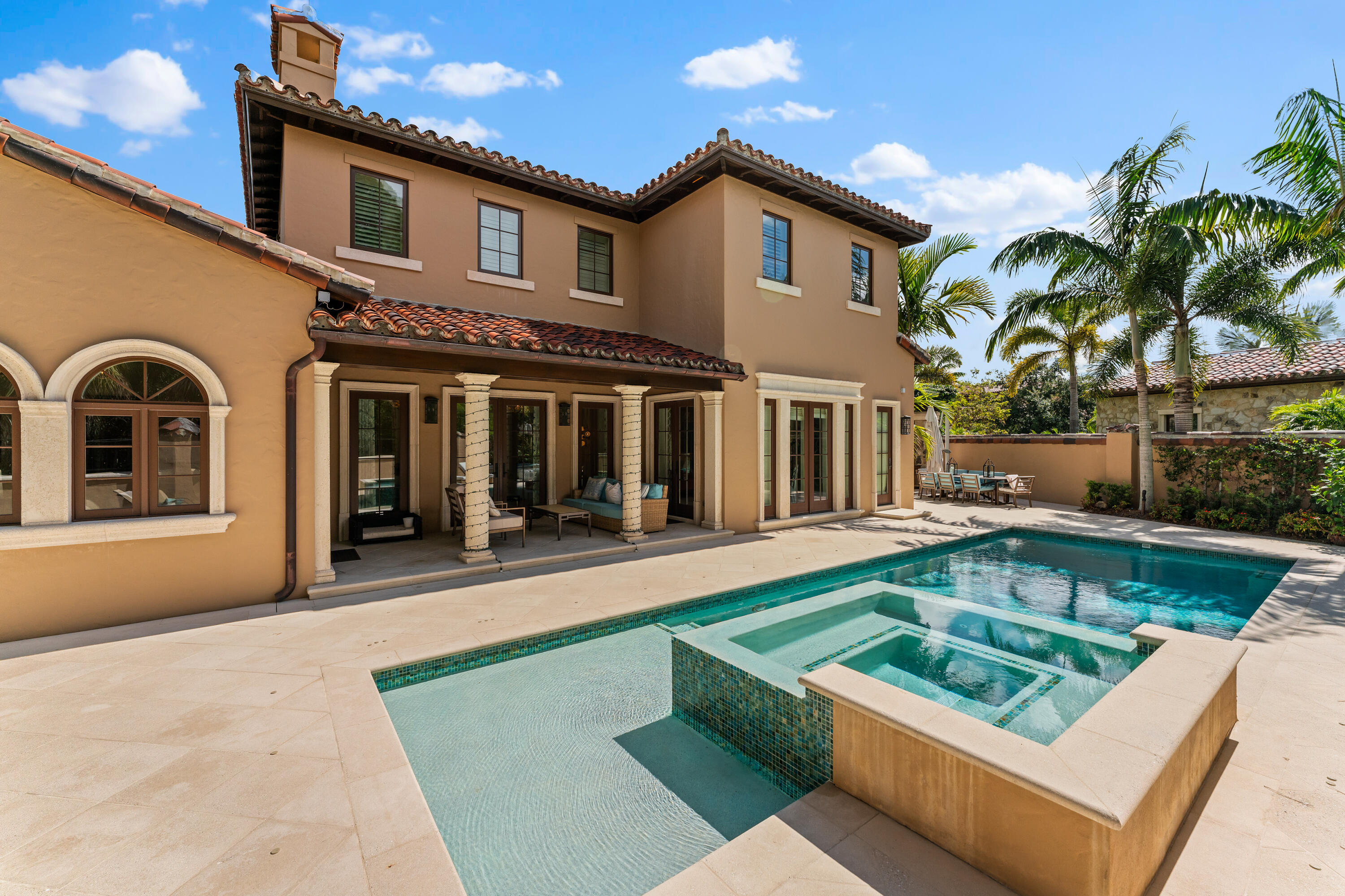 426 Via Del Orso Drive Jupiter, FL 33477 - Photo 46 of 54 a view of a house with pool lawn chairs and couches