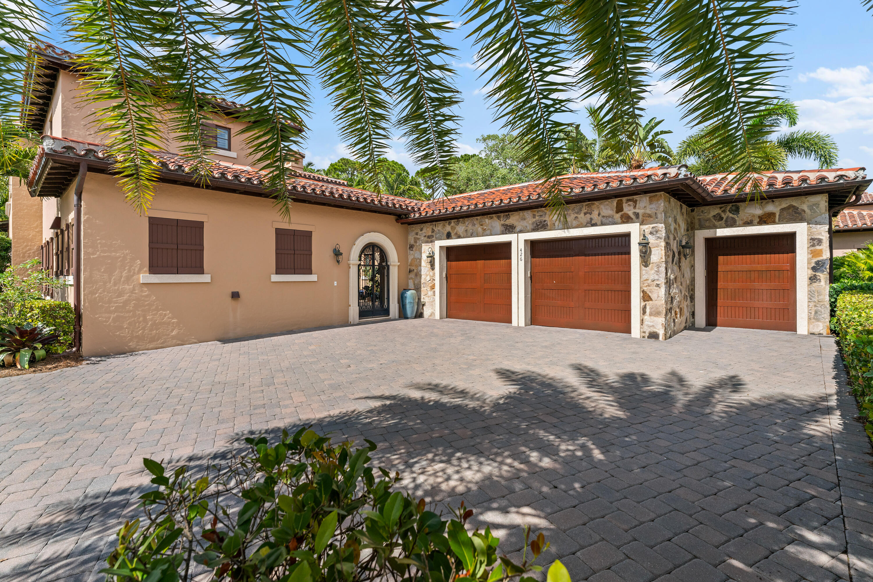 426 Via Del Orso Drive Jupiter, FL 33477 - Photo 6 of 54 a front view of a house with a yard and garage