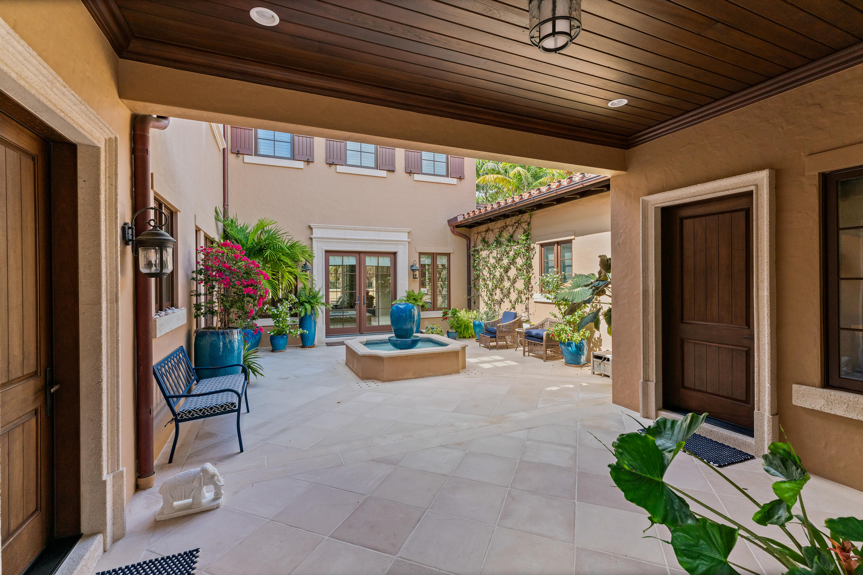 426 Via Del Orso Drive Jupiter, FL 33477 - Photo 8 of 54 a view of a patio with table and chairs and potted plants