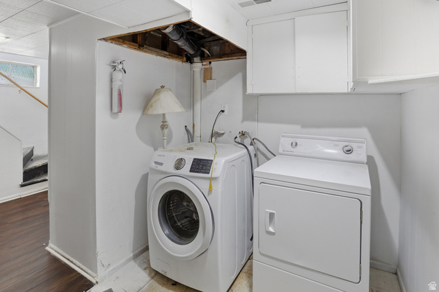 774 37th Street South Ogden, UT 84403 - Photo 24 of 47 Dedicated laundry area featuring a washer and dryer, white cabinetry, and wood-finish flooring extending into the adjacent space