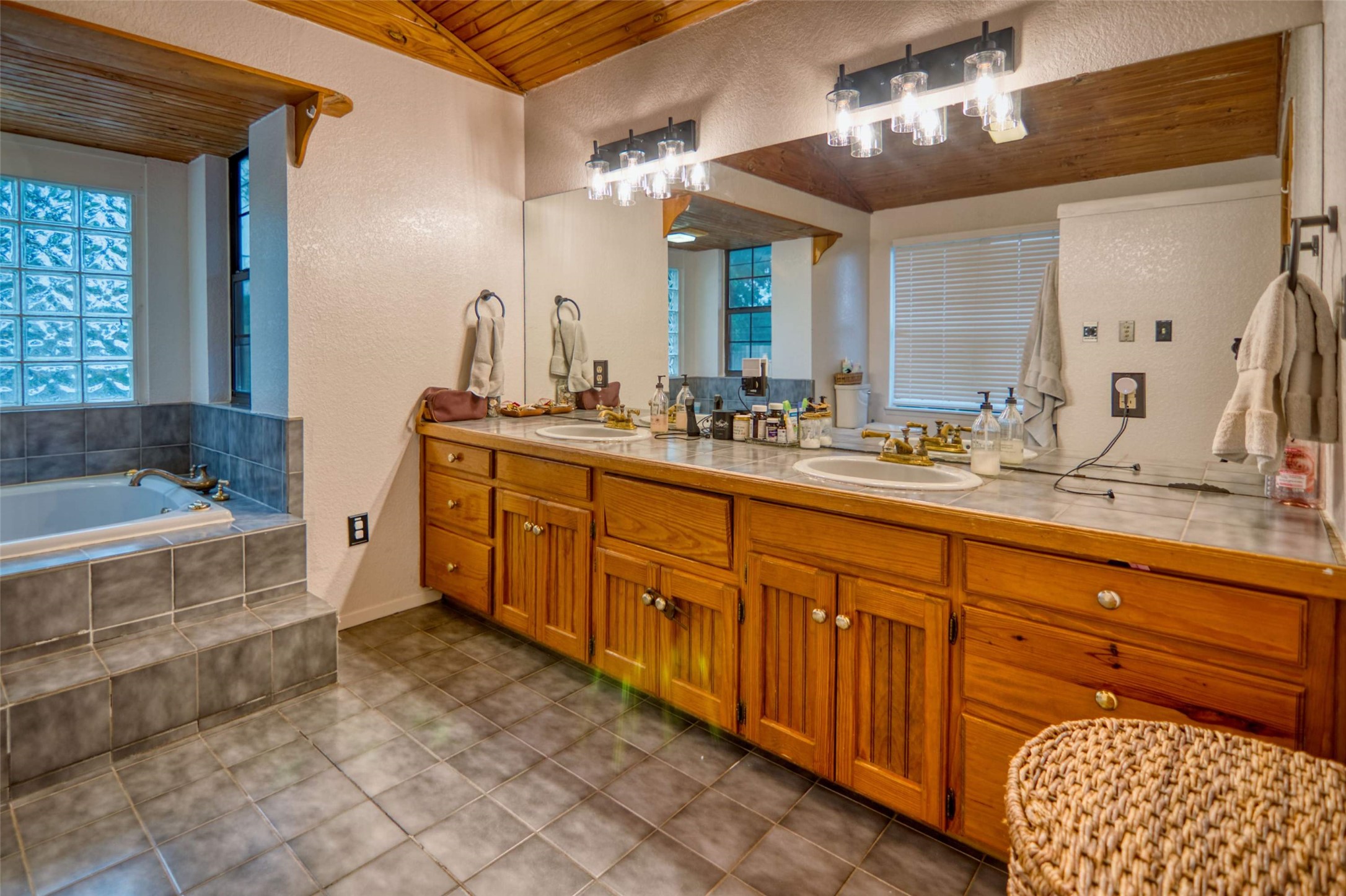 904 Bluebonnet Road Mason, TX 76856 - Photo 17 of 28 Double vanity featuring wood cabinetry and an integrated countertop with dual undermount sinks
